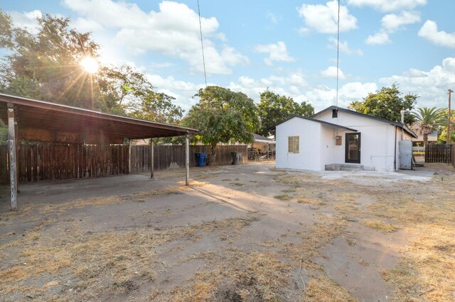 exterior space with fence and a carport