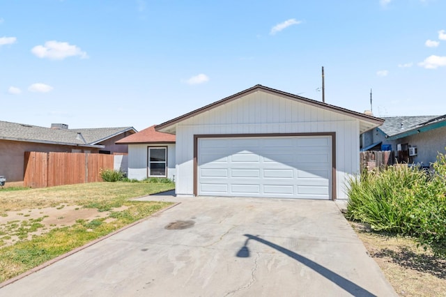 ranch-style home with fence, driveway, and an attached garage