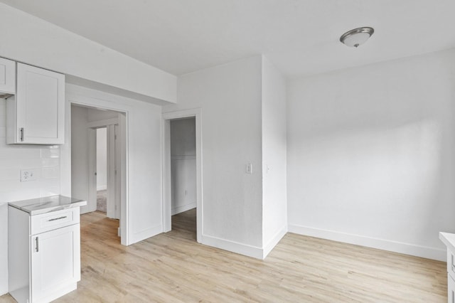 interior space featuring light wood finished floors and baseboards