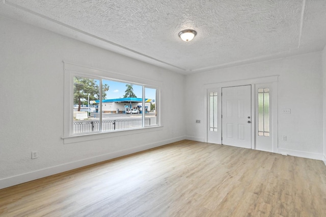 entryway featuring a textured ceiling, baseboards, and wood finished floors