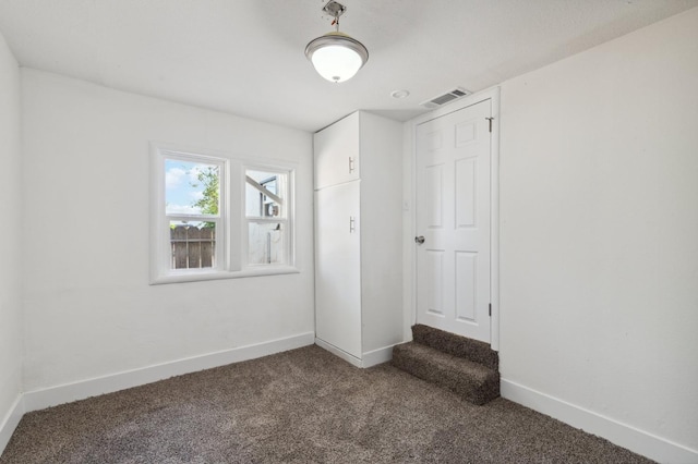 unfurnished bedroom featuring visible vents, baseboards, and carpet flooring