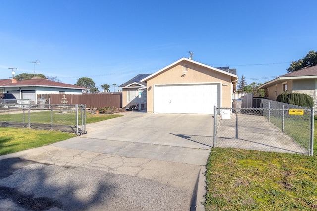 single story home with a front yard, a gate, fence, driveway, and stucco siding