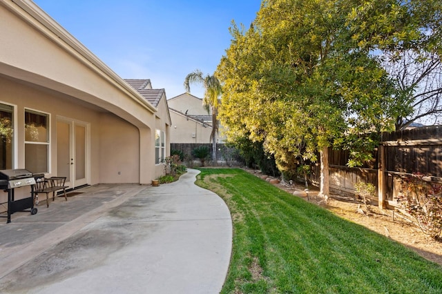 view of yard featuring a patio area and a fenced backyard