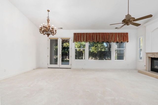 unfurnished living room featuring carpet floors, a healthy amount of sunlight, and a high end fireplace