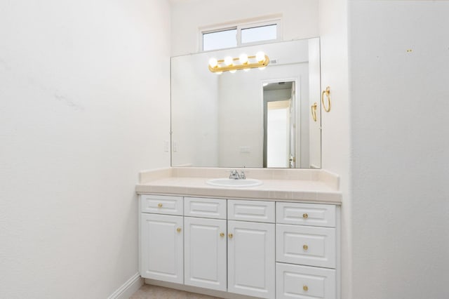 bathroom with vanity and baseboards