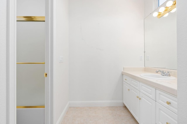 bathroom featuring tile patterned floors, baseboards, and vanity