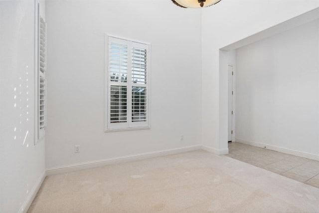 empty room featuring baseboards and carpet flooring