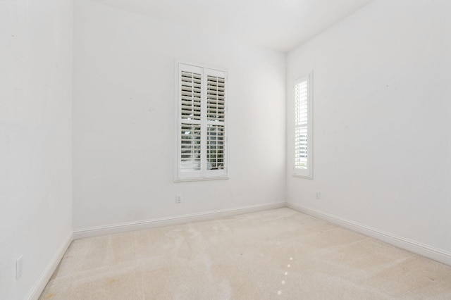 carpeted empty room with baseboards