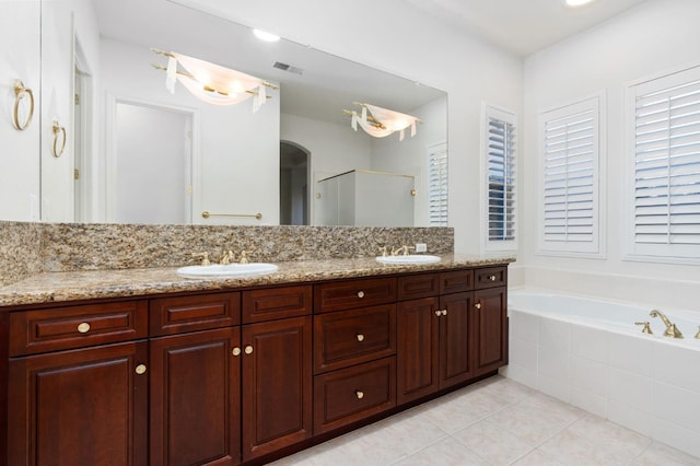 bathroom featuring a stall shower, tile patterned flooring, visible vents, and a sink