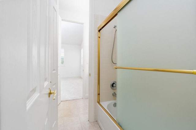 bathroom featuring shower / bath combination with glass door and tile patterned flooring