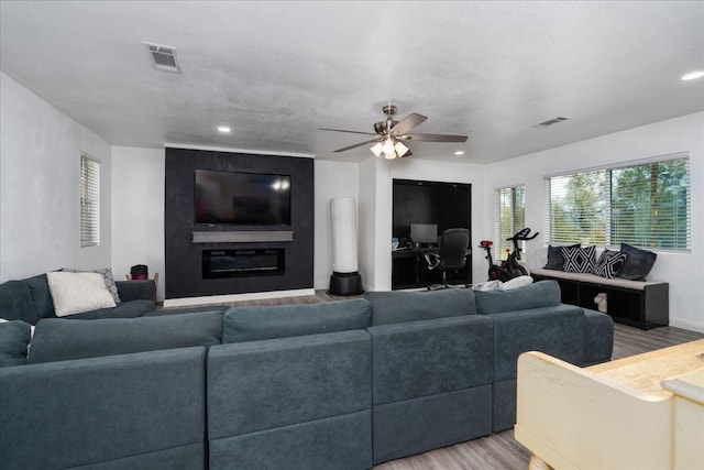 29598 Jim Bowie Ct, Coarsegold, CA 93614 - living room with light wood-style flooring, a fireplace, visible vents, and ceiling fan