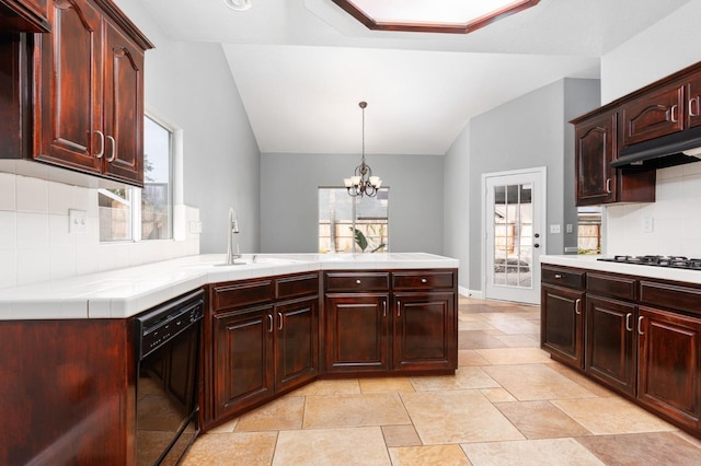 kitchen featuring vaulted ceiling, black appliances, a sink, and tile countertops