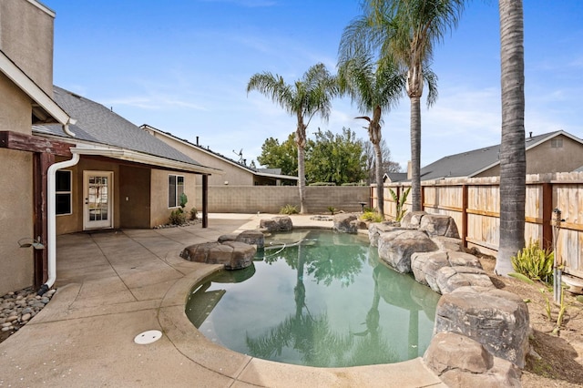 view of swimming pool with a patio area, a fenced backyard, and a fenced in pool