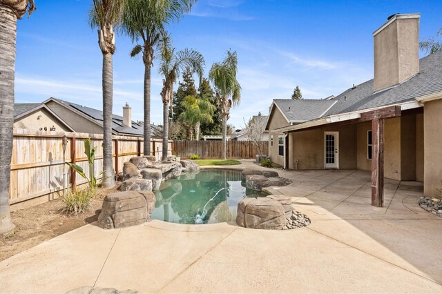 view of pool featuring a patio area and a fenced backyard