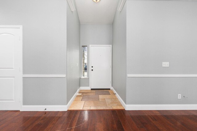 foyer entrance featuring hardwood / wood-style flooring and baseboards