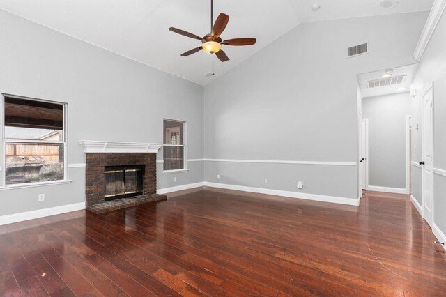 unfurnished living room with hardwood / wood-style floors, a brick fireplace, and visible vents