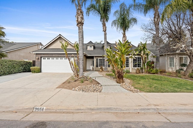 view of front of home featuring a garage, driveway, and a front yard