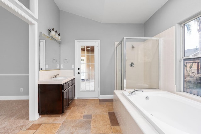 full bath with a garden tub, a shower stall, vanity, and baseboards