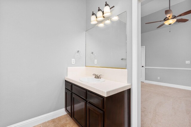 bathroom featuring ceiling fan, vanity, and baseboards