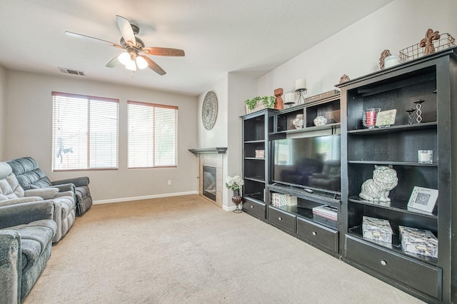 4466 W Artemisa Dr, Fresno, CA 93722 - carpeted living area with baseboards, visible vents, a ceiling fan, and a tile fireplace