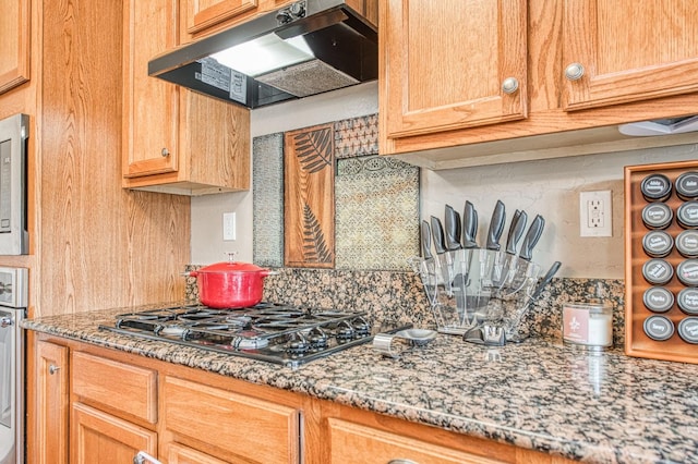 4466 W Artemisa Dr, Fresno, CA 93722 - kitchen featuring stainless steel appliances, decorative backsplash, light stone countertops, and under cabinet range hood