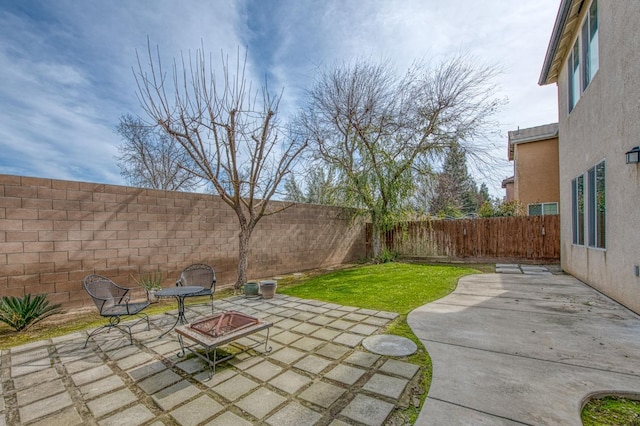 4466 W Artemisa Dr, Fresno, CA 93722 - view of yard featuring an outdoor fire pit, a fenced backyard, and a patio
