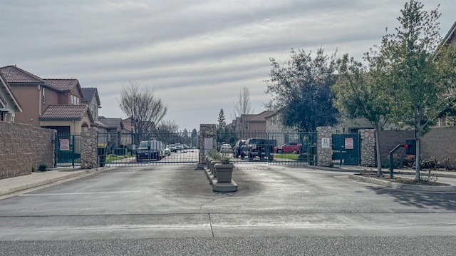 4466 W Artemisa Dr, Fresno, CA 93722 - view of street featuring sidewalks, a gate, a gated entry, and curbs