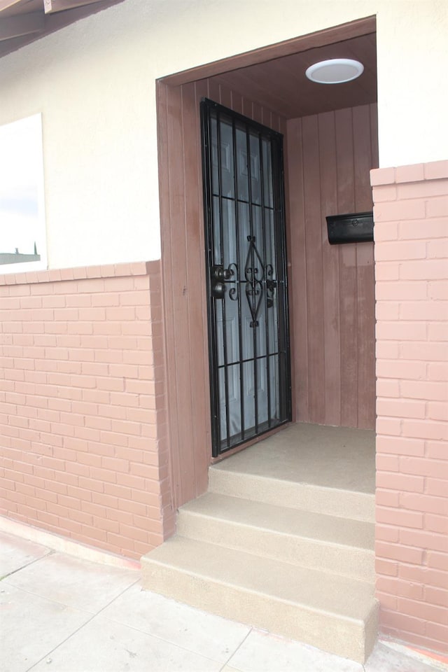 entrance to property with brick siding