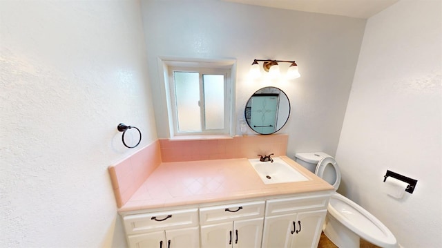 bathroom featuring toilet and vanity