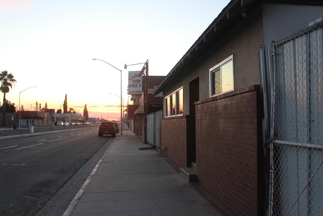 view of home's exterior featuring fence and brick siding