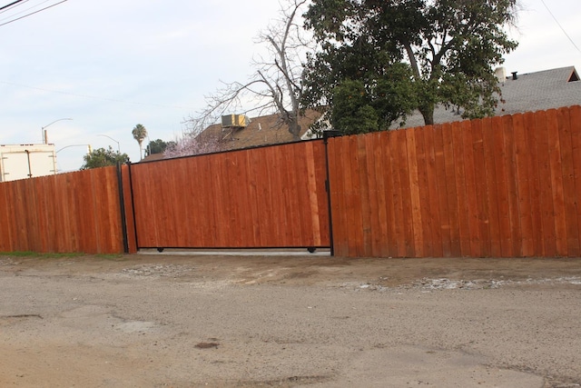 view of gate with fence