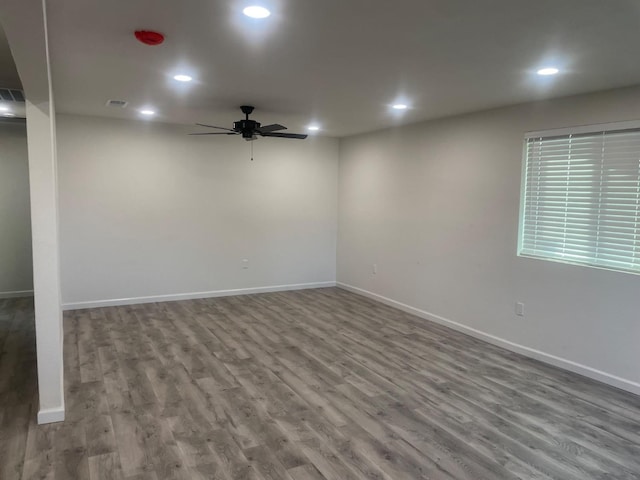 spare room featuring a ceiling fan, baseboards, wood finished floors, and recessed lighting