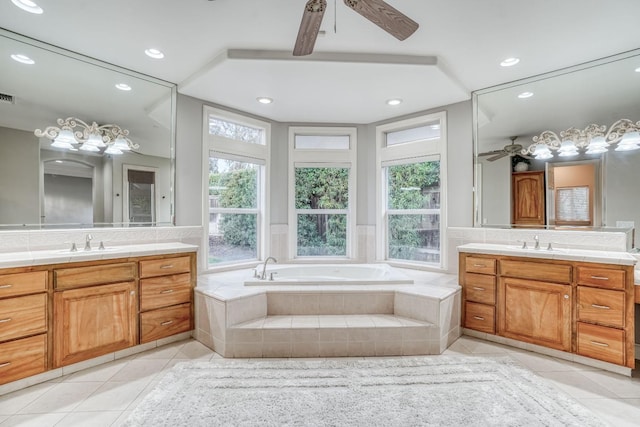 bathroom featuring plenty of natural light, tile patterned flooring, two vanities, and a sink