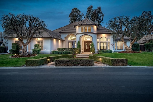 view of front of house with a front yard and stucco siding