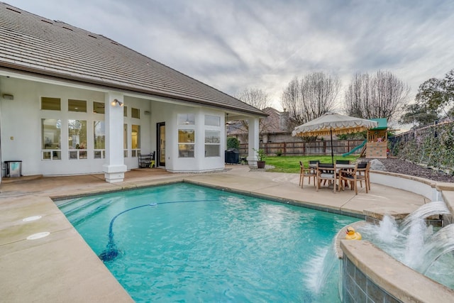 view of swimming pool featuring a fenced in pool, a playground, a patio, and fence