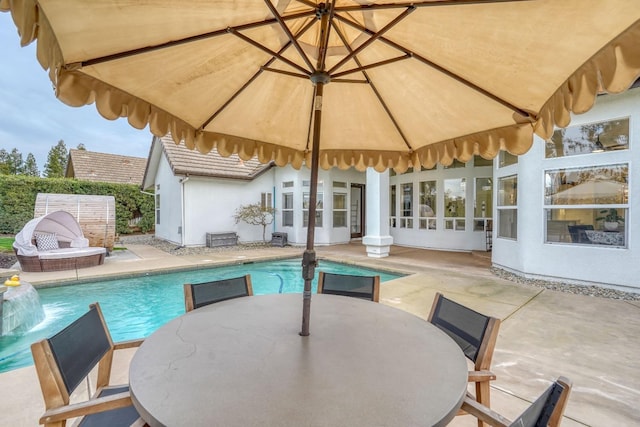 view of pool with a fenced in pool, outdoor dining space, and a patio area