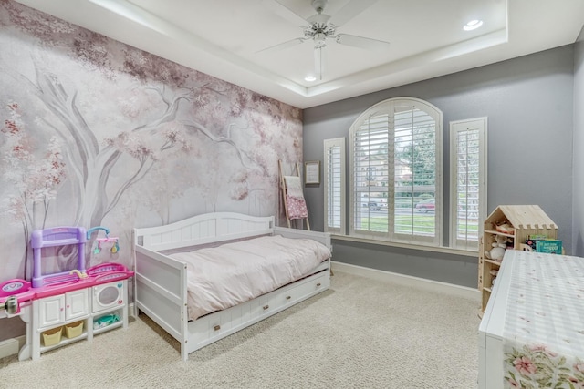 bedroom with carpet, recessed lighting, a raised ceiling, and baseboards