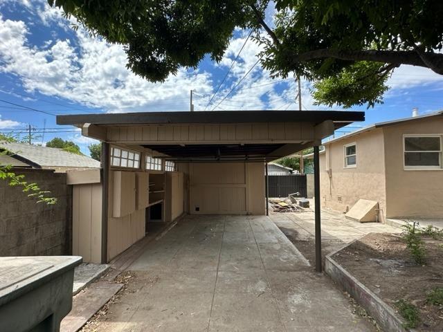 view of car parking featuring fence