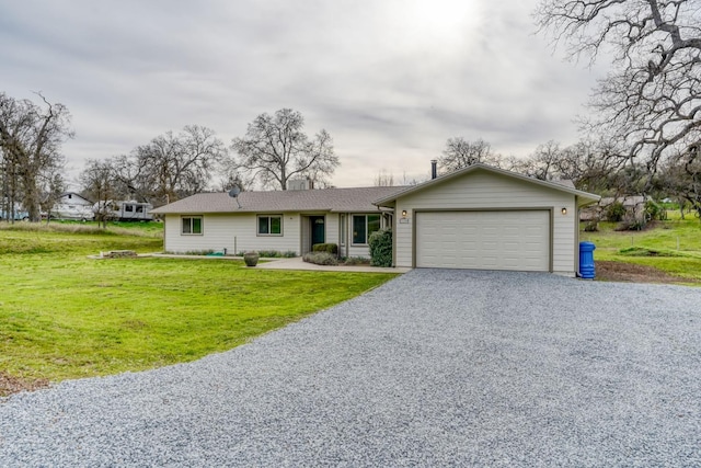 ranch-style home with driveway, an attached garage, and a front lawn