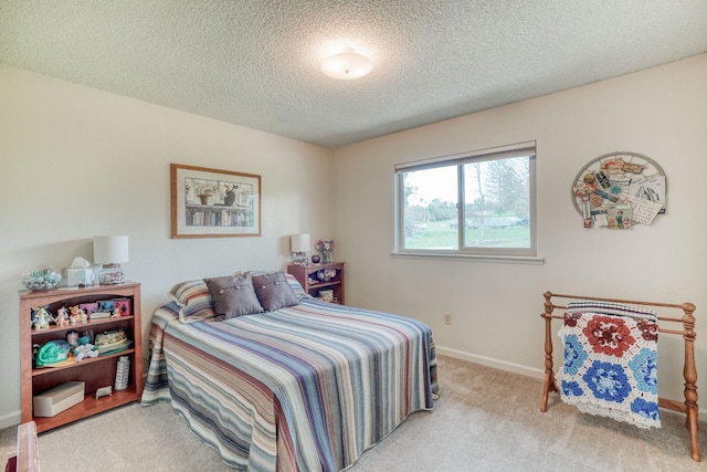 bedroom featuring carpet floors, a textured ceiling, and baseboards