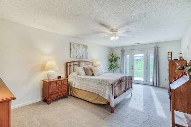 bedroom with a textured ceiling, light carpet, a ceiling fan, baseboards, and access to exterior