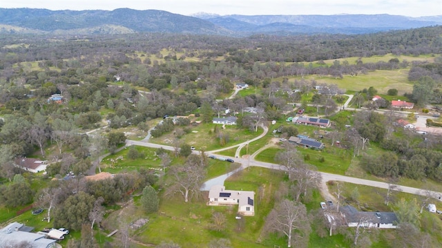 aerial view featuring a mountain view and a wooded view