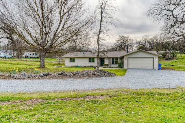 ranch-style home with driveway, a front lawn, and an attached garage