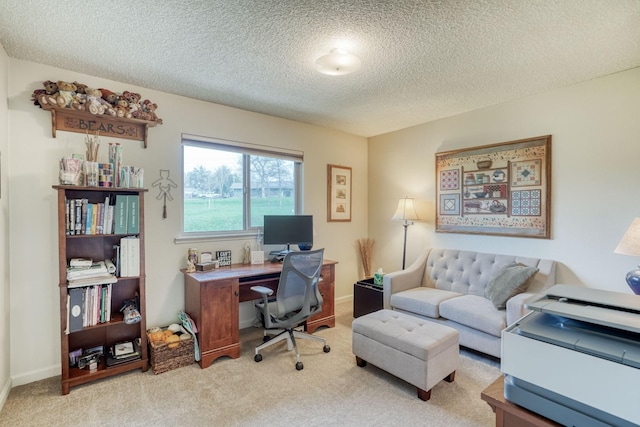 home office featuring carpet flooring, a textured ceiling, and baseboards