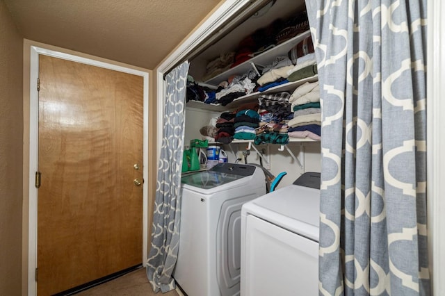 laundry area featuring a textured ceiling and separate washer and dryer