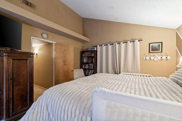 bedroom featuring carpet, visible vents, vaulted ceiling, and a textured ceiling