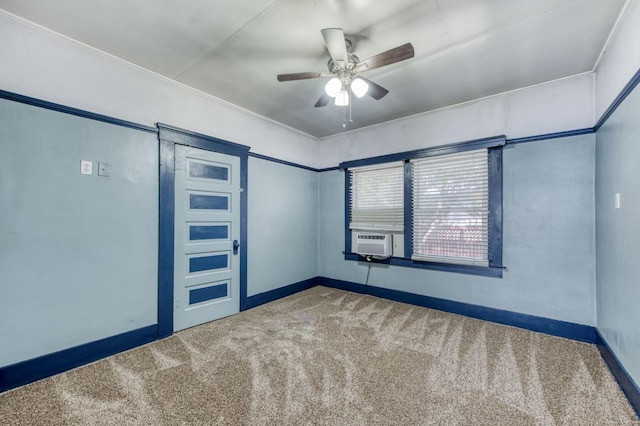 spare room with ceiling fan, cooling unit, carpet flooring, and baseboards