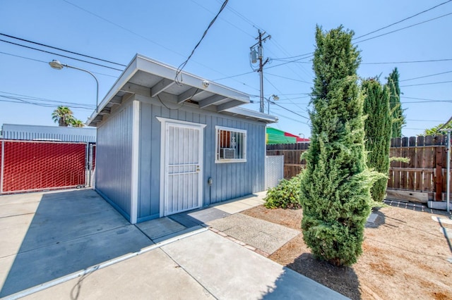 view of outdoor structure with an outbuilding and fence