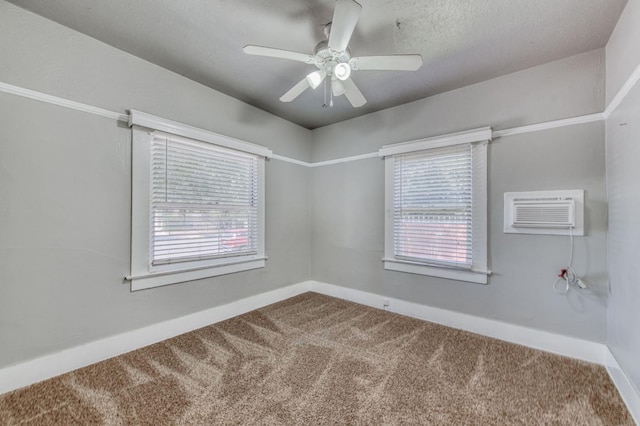 spare room with plenty of natural light, carpet floors, ceiling fan, and a wall unit AC