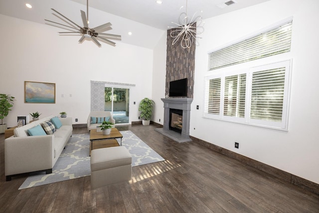 living room with a large fireplace, high vaulted ceiling, hardwood / wood-style floors, and baseboards